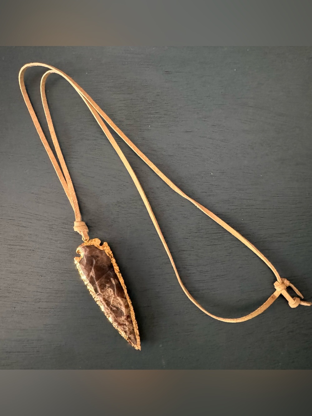 Arrowhead pendant on leather necklace string